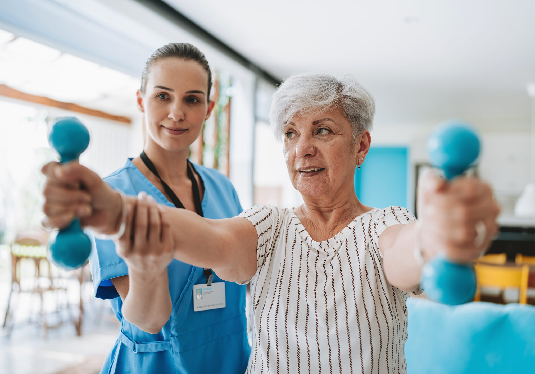 Patient at home doing physiotherapy with dumbbell