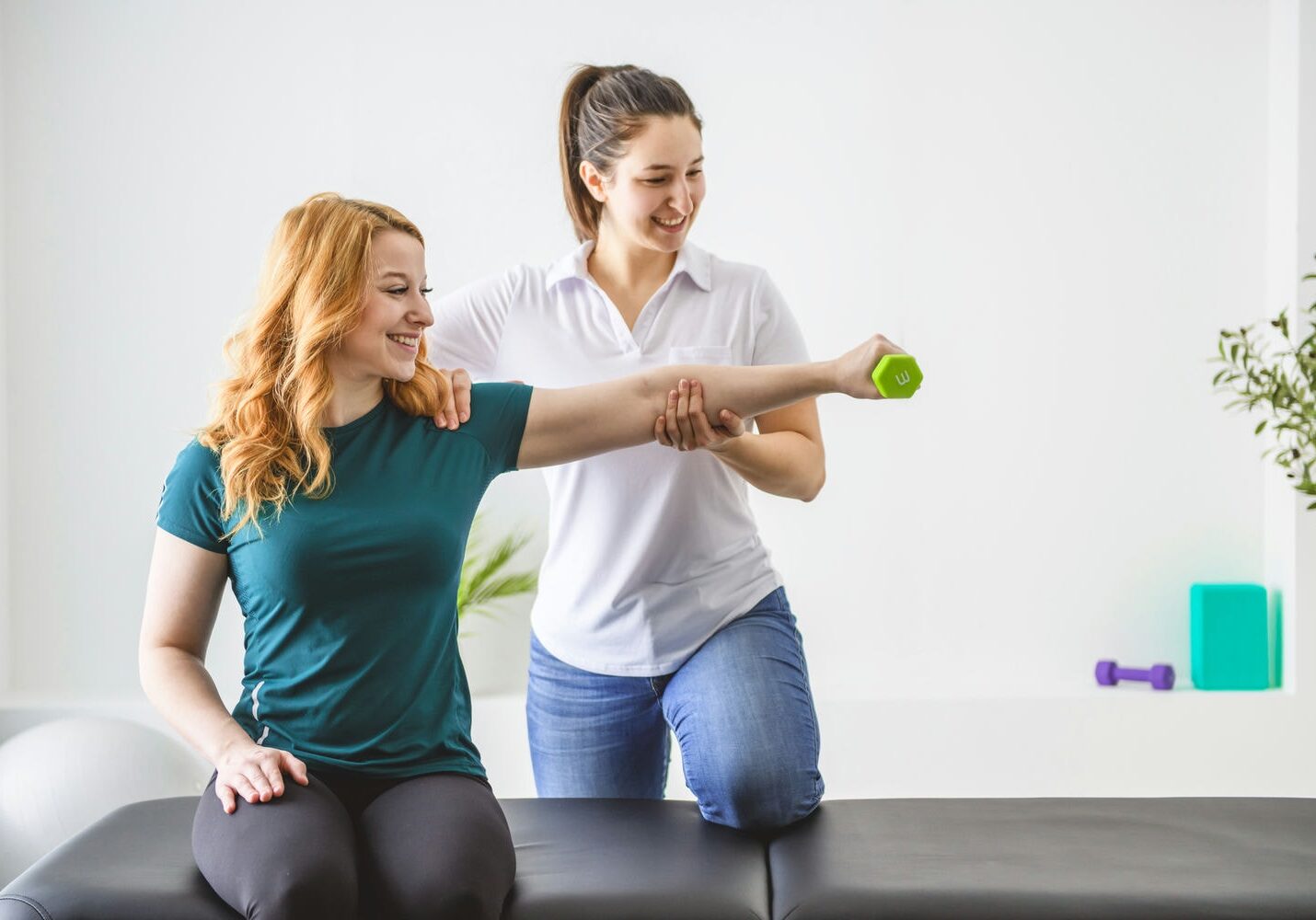 Therapist guiding a patient through light band exercises to build strength and manage chronic pain.